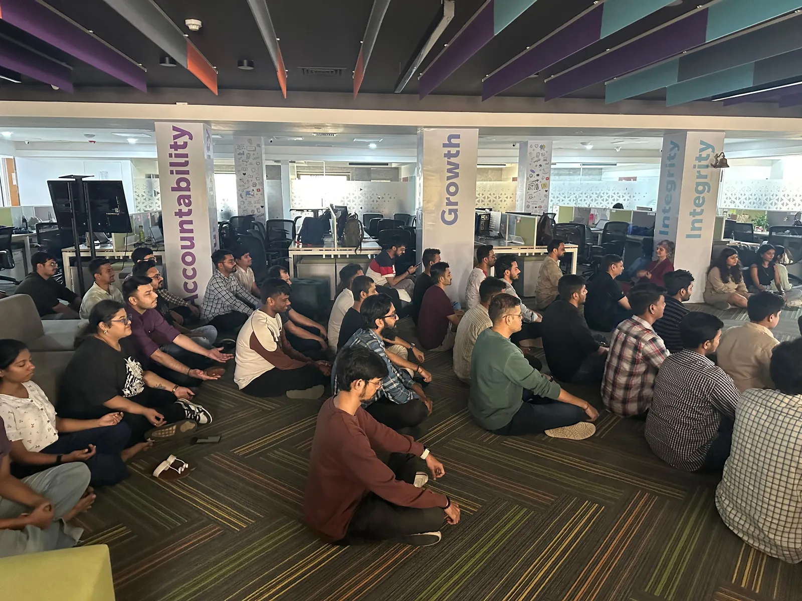 The team seated together at an all-hands session