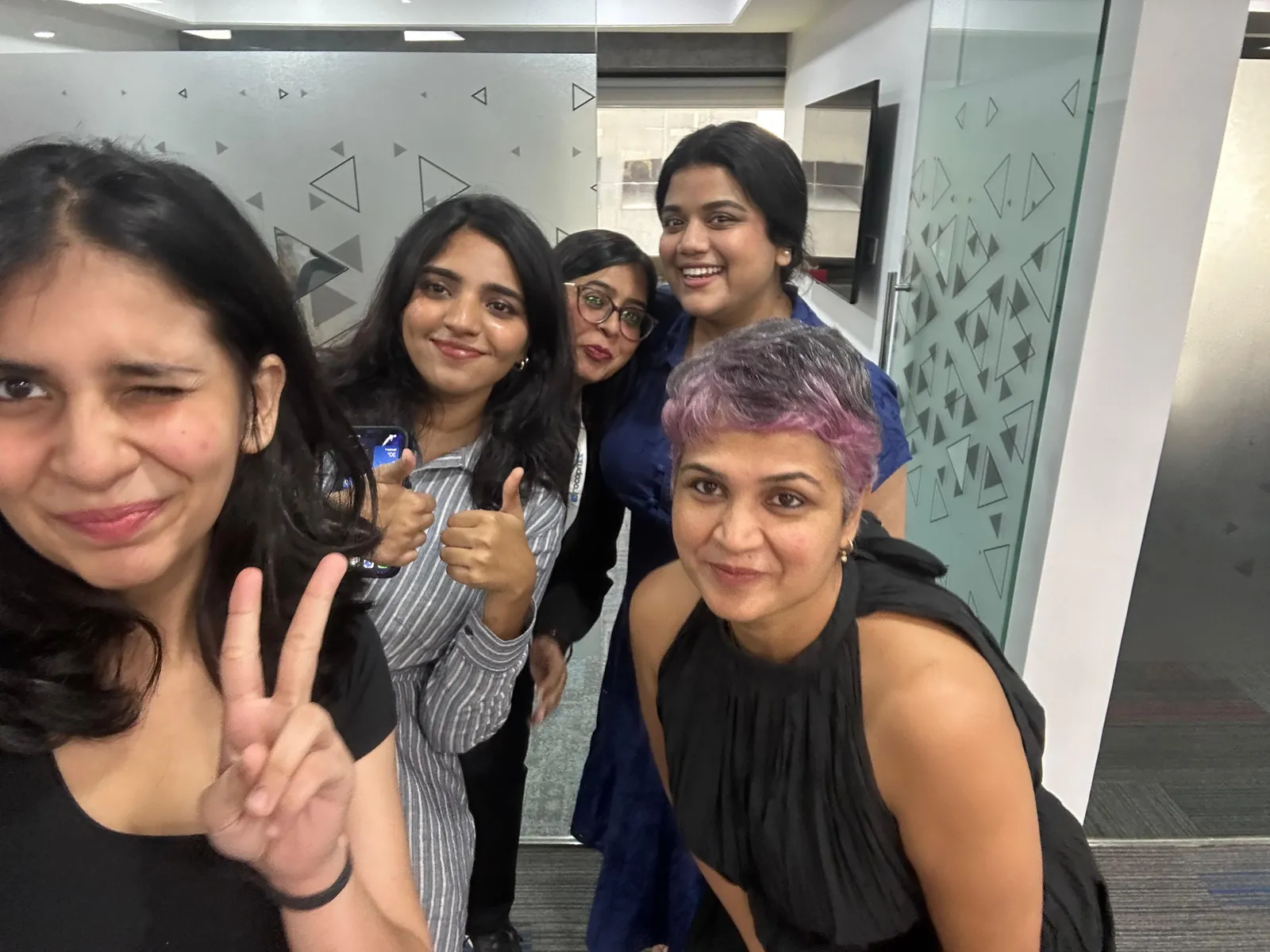 Colleagues posing for a selfie in the office
